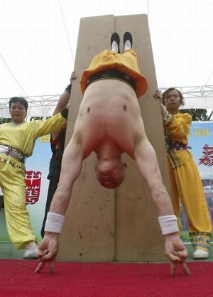 A handstand supported by only 4 fingers. (Getty Images)