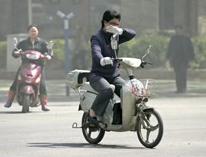 A motorist covered her nose against the severe air pollution (AFP/Getty Images)