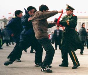 A Falun Gong practitioner is assaulted by police and soldiers in Tiananmen Square in Beijing. (Clearwisdom.net)