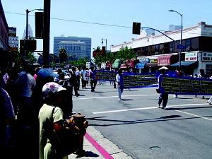 Los Angeles Chinatown vendors, shoppers, residents and tourists stopped what they were doing to watch the 'Quit the Chinese Communist Party' parade contingent that marched through Chinatown three consecutive times. (Epoch Times)