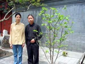 During his final years, Zhao liked pure white magnolia flowers and tended the magnolia tree in the yard. On the first Qingming festival after his death, 26 magnolia flowers suddenly came into full bloom. The picture shows Zhao Xin and Wang Yannan in front of the magnolia tree. (The Epoch Times)
