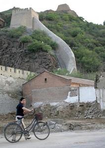 A woman passing by a ruined segment of the Great Wall at Zhang Jia Kou. (Frederic J. Brown/AFP/Getty Images)