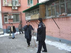 On the afternoon of February 9, while under house arrest, Mr. Qi Zhiyong was making a telephone call at his front door. (The Epoch Times)