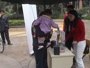People solicit contributions for Li Gang in Meilin Coast Garden on March 5. (The Epoch Times)