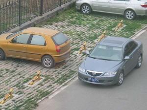 "The gold car belongs to me; the gray one is the undercover police car that was following me. Their car blocked my way out from my Beijing home on June 20, 2006." (Hu Jia)