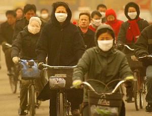 Cyclists brave a sandstorm in the northeastern Chinese city of Shenyang.   (AFP/Getty Images)