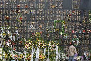 July 28 2006 is the 30th anniversary of the Tangshan earthquake. Residents from Tangshan city and tourists present flowers at the memorial wall in commemoration of the dead. (China Photos/Getty Images)