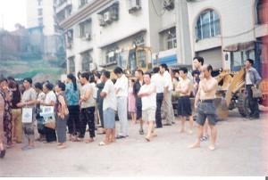 Villagers and observers standing outside the security line (June 28). (The Epoch Times)