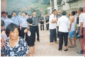 Villagers and observers standing outside the security line (June 28). (The Epoch Times)