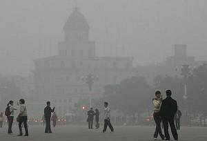 People walk around Tiananmen Square shrouded with smog, Beijing, China. (China Photos/Getty Images)
