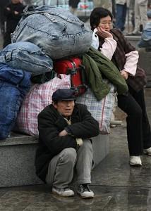 Two travelers preparing to return to their villages with their large luggage in Shanghai. (Getty Images)