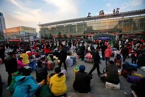 Passengers waiting outside a train station in Shanghai. (Getty Images)