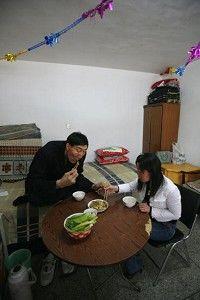 Bao Xishun,shares a meal with his bride. (China Photos/Getty Images)
