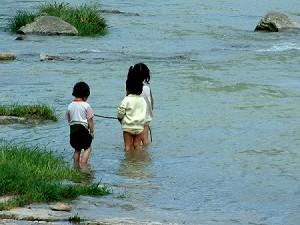 Children playing in the river during the day. Their families cannot afford to send them to school. (Ben Ben)
