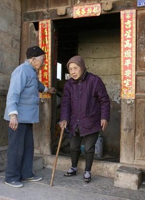 An elderly woman with bound feet heads out for a walk. (Getty Images)