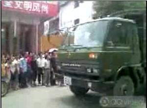 A military vehicle arrives to disperse the crowd. (The Epoch Times)