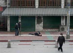 A man lies injured in the street March 14, 2008 during protests in Lhasa, Tibet. (phayul.com)