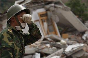 A Chinese soldier wipes his eyes while searching for earthquake victims in a quake ravaged town, May 15, 2008 in Beichuan, Sichuan province, China. Nearly 26,000 people remained buried in collapsed buildings, and the death toll is expected to climb. (Photo: Paula Bronstein/Getty Images)