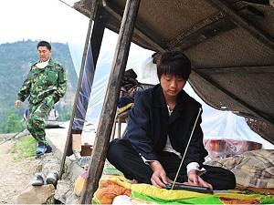 A quake survivor listens to news on the radio from a makeshift shelter near the deserted quake-ravaged town of Beichuan, which was closed off for fear of aftershocks and landslides on May 20, 2008 in southwest China's quake-stricken Sichuan province. (Frederic J. Brown/AFP/Getty Images)