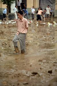 A man walking in the mud after the flood in Lechang city, Guangdong province, China. (AFP)
