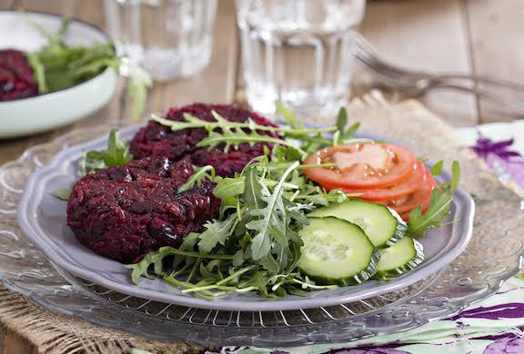 Vegan burgers with beetroot and beans served with fresh vegetables (eluxemagazine.com)