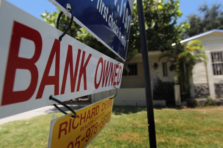<a><img src="https://www.theepochtimes.com/assets/uploads/2015/09/103157625.jpg" alt="A bank owned sign is seen in front of a foreclosed home July 29, 2010 in Miami, Florida. (Joe Raedle/Getty Images)" title="A bank owned sign is seen in front of a foreclosed home July 29, 2010 in Miami, Florida. (Joe Raedle/Getty Images)" width="320" class="size-medium wp-image-1816848"/></a>