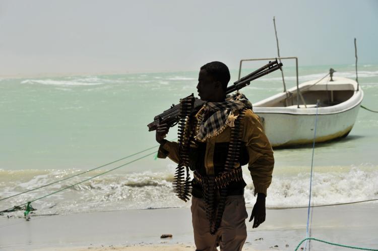 <a><img src="https://www.theepochtimes.com/assets/uploads/2015/09/103759205.jpg" alt="A Somali pirate carries his high-caliber weapon on a beach in the central Somali town of Hobyo on August 20, 2010. (Roberto Schmidt/AFP/Getty Images)" title="A Somali pirate carries his high-caliber weapon on a beach in the central Somali town of Hobyo on August 20, 2010. (Roberto Schmidt/AFP/Getty Images)" width="320" class="size-medium wp-image-1805528"/></a>