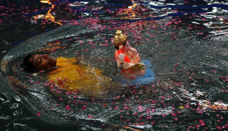 <a><img src="https://www.theepochtimes.com/assets/uploads/2015/09/104021481.jpg" alt="An Indian Hindu swims with an idol of the elephant-headed Hindu god Lord Ganesha before immersing it inside an environmentally friendly artificial pond in Mumbai on Sept. 12. (INDRANIL MUKHERJEE/AFP/Getty Images)" title="An Indian Hindu swims with an idol of the elephant-headed Hindu god Lord Ganesha before immersing it inside an environmentally friendly artificial pond in Mumbai on Sept. 12. (INDRANIL MUKHERJEE/AFP/Getty Images)" width="320" class="size-medium wp-image-1814905"/></a>
