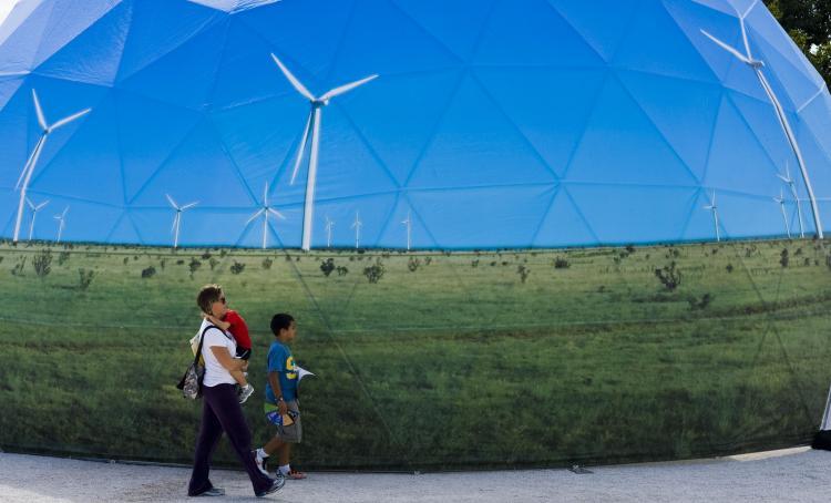 <a><img src="https://www.theepochtimes.com/assets/uploads/2015/09/107347535.jpg" alt="A family passes by one of the stands promoting green energy at the Climate Village in Cancun, Mexico, on Dec. 4. (Omar Torres/AFP/Getty Images)" title="A family passes by one of the stands promoting green energy at the Climate Village in Cancun, Mexico, on Dec. 4. (Omar Torres/AFP/Getty Images)" width="320" class="size-medium wp-image-1811053"/></a>