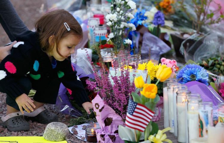 <a><img src="https://www.theepochtimes.com/assets/uploads/2015/09/107950105.jpg" alt="A young girl places a rock on a sign at the makeshift memorial outside of the District Office of U.S. Rep. Gabrielle Giffords (D-AZ) a day after a gunman opened fire during a public event at a Safeway store on January 9, in Tucson, Arizona.  ( Kevin C. Cox/Getty Images)" title="A young girl places a rock on a sign at the makeshift memorial outside of the District Office of U.S. Rep. Gabrielle Giffords (D-AZ) a day after a gunman opened fire during a public event at a Safeway store on January 9, in Tucson, Arizona.  ( Kevin C. Cox/Getty Images)" width="320" class="size-medium wp-image-1809895"/></a>