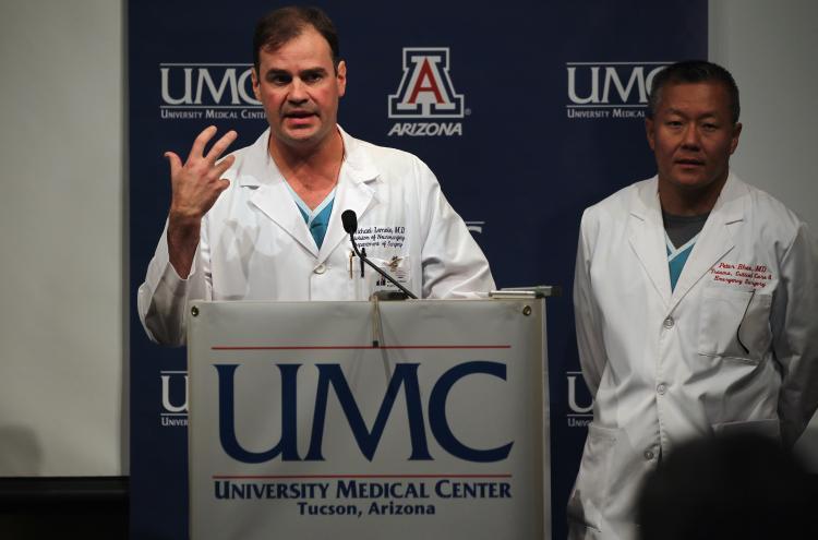 <a><img src="https://www.theepochtimes.com/assets/uploads/2015/09/107959480.jpg" alt="Gabrielle Giffords surviving: Dr. Michael Lemole, chief neurosurgeon at University Medical Center, speaks on Jan. 10, 2011 in Tuscon, Arizona. At right is trauma director Dr. Peter Rhee. (John Moore/Getty Images)" title="Gabrielle Giffords surviving: Dr. Michael Lemole, chief neurosurgeon at University Medical Center, speaks on Jan. 10, 2011 in Tuscon, Arizona. At right is trauma director Dr. Peter Rhee. (John Moore/Getty Images)" width="320" class="size-medium wp-image-1809829"/></a>