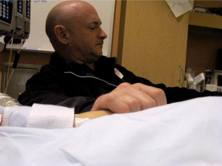 <a><img src="https://www.theepochtimes.com/assets/uploads/2015/09/107996347.jpg" alt="Gabrielle Giffords' husband, Mark Kelly, holds his wife's hand in the congresswoman's hospital room at University Medical Center Jan. 9, 2011 in Tucson, Ariz. (U.S. Rep. Gabrielle Giffords' office via Getty Images)" title="Gabrielle Giffords' husband, Mark Kelly, holds his wife's hand in the congresswoman's hospital room at University Medical Center Jan. 9, 2011 in Tucson, Ariz. (U.S. Rep. Gabrielle Giffords' office via Getty Images)" width="320" class="size-medium wp-image-1809749"/></a>