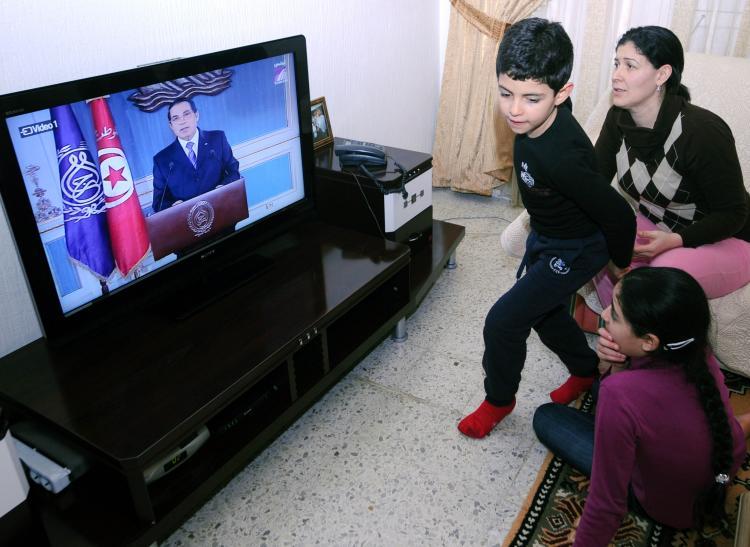 <a><img src="https://www.theepochtimes.com/assets/uploads/2015/09/108024676COLOR.jpg" alt="A Tunisian family watches a televised speech of President Zine el-Abidine Ben Ali. In an attempt to stop mounting protests in the country, Ben Ali promised to resign in 2014. But experts doubt whether Ben Ali will keep his promise.  (Fethi Belaid/AFP/Getty Images)" title="A Tunisian family watches a televised speech of President Zine el-Abidine Ben Ali. In an attempt to stop mounting protests in the country, Ben Ali promised to resign in 2014. But experts doubt whether Ben Ali will keep his promise.  (Fethi Belaid/AFP/Getty Images)" width="320" class="size-medium wp-image-1809691"/></a>