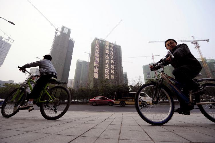 <a><img src="https://www.theepochtimes.com/assets/uploads/2015/09/108470648.jpg" alt="Cyclists ride past a construction site in southwest China's Chongqing municipality on Jan. 28. China launched a long-awaited property tax in two of the country's biggest cities, but the mayor of Chongqing in the southwest warned the measure was not a cure-all for soaring prices. (STR/AFP/Getty Images)" title="Cyclists ride past a construction site in southwest China's Chongqing municipality on Jan. 28. China launched a long-awaited property tax in two of the country's biggest cities, but the mayor of Chongqing in the southwest warned the measure was not a cure-all for soaring prices. (STR/AFP/Getty Images)" width="320" class="size-medium wp-image-1804045"/></a>