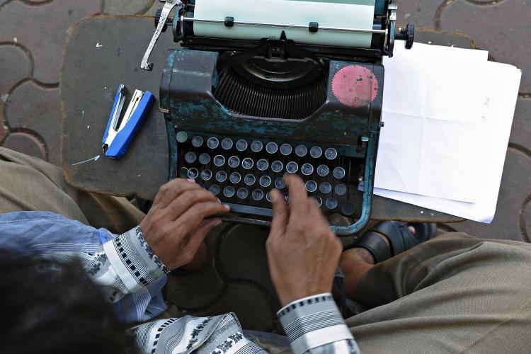 <a><img src="https://www.theepochtimes.com/assets/uploads/2015/09/109363830.jpg" alt="Professional typist Purushottam Sakhare typing an affidavit on his typewriter at a sidewalk outside a city court in Mumbai on Feb. 15. (Indranil Mukherjee/AFP/Getty Images)" title="Professional typist Purushottam Sakhare typing an affidavit on his typewriter at a sidewalk outside a city court in Mumbai on Feb. 15. (Indranil Mukherjee/AFP/Getty Images)" width="320" class="size-medium wp-image-1804924"/></a>