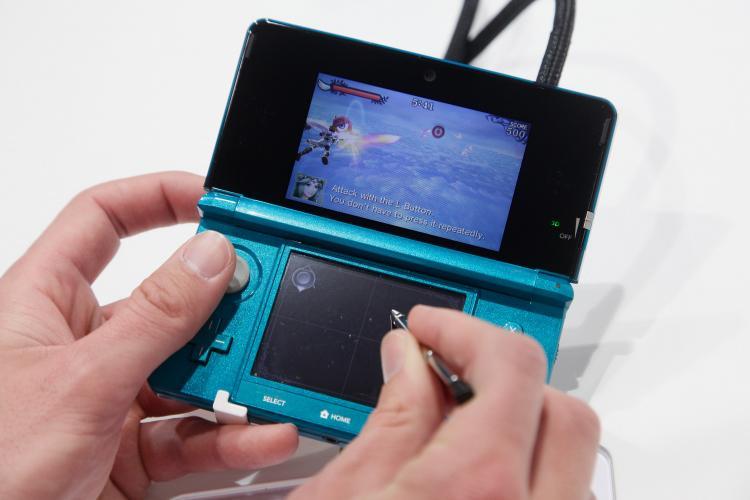 <a><img src="https://www.theepochtimes.com/assets/uploads/2015/09/109707564-nin.jpg" alt="Visitors try out the new Nintendo 3DS handheld gaming device with a 3D display at the Nintendo DS stand at the CeBIT technology trade fair on March 2, in Hanover, Germany. Sean Gallup/Getty Images (Sean Gallup/Getty Images)" title="Visitors try out the new Nintendo 3DS handheld gaming device with a 3D display at the Nintendo DS stand at the CeBIT technology trade fair on March 2, in Hanover, Germany. Sean Gallup/Getty Images (Sean Gallup/Getty Images)" width="320" class="size-medium wp-image-1804844"/></a>