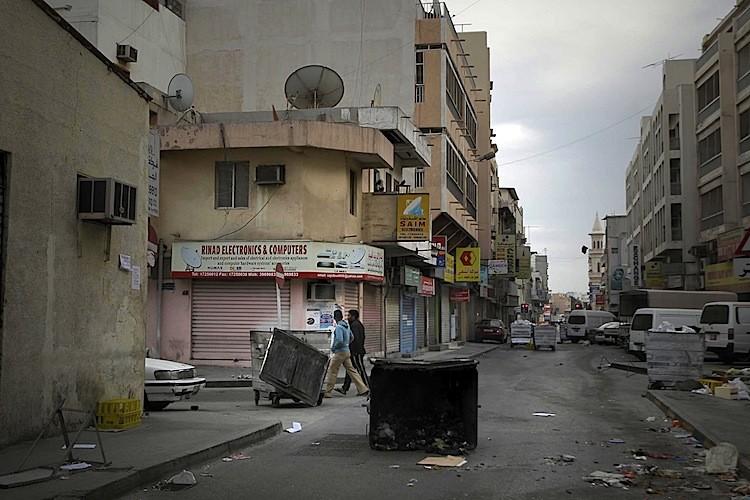 <a><img src="https://www.theepochtimes.com/assets/uploads/2015/09/110173833.jpg" alt="Bahraini youths walk past garbarge containers blocking streets during curfew hours in the capital Manama on March 16, after government forces raided a month-old pro-democracy sit-in.  (Joseph Eid/AFP/Getty Images)" title="Bahraini youths walk past garbarge containers blocking streets during curfew hours in the capital Manama on March 16, after government forces raided a month-old pro-democracy sit-in.  (Joseph Eid/AFP/Getty Images)" width="320" class="size-medium wp-image-1803120"/></a>