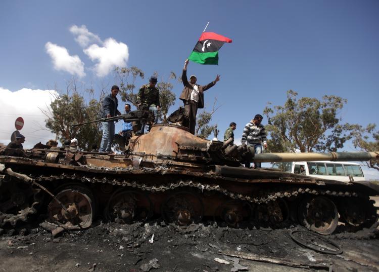 <a><img src="https://www.theepochtimes.com/assets/uploads/2015/09/110488147Libyarebels.jpg" alt="HELP HAS ARRIVED: Libyan rebels wave their flag on top of a wrecked tank belonging to Moammer Gadhafi's forces at the western entrance of Benghazi March 20. A five-nation coalition of Western countries began operations Saturday to enforce a no-fly zone in Libya. (Patrick Baz/Getty Images)" title="HELP HAS ARRIVED: Libyan rebels wave their flag on top of a wrecked tank belonging to Moammer Gadhafi's forces at the western entrance of Benghazi March 20. A five-nation coalition of Western countries began operations Saturday to enforce a no-fly zone in Libya. (Patrick Baz/Getty Images)" width="320" class="size-medium wp-image-1806572"/></a>