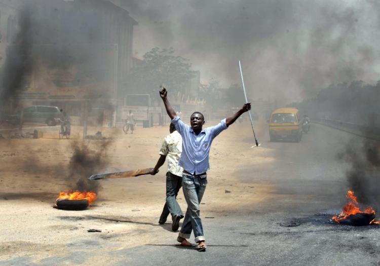 <a><img src="https://www.theepochtimes.com/assets/uploads/2015/09/112297878.jpg" alt="People holding wooden and metal sticks demonstrate in Nigeria's northern city of Kano where running battles broke out between protesters and soldiers on April 18, 2011 as President Goodluck Jonathan headed for an election win.  (Seyllou Diallo/AFP/Getty Image)" title="People holding wooden and metal sticks demonstrate in Nigeria's northern city of Kano where running battles broke out between protesters and soldiers on April 18, 2011 as President Goodluck Jonathan headed for an election win.  (Seyllou Diallo/AFP/Getty Image)" width="320" class="size-medium wp-image-1805021"/></a>