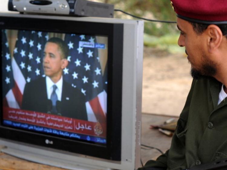 <a><img src="https://www.theepochtimes.com/assets/uploads/2015/09/114419409.jpg" alt="A Libyan rebel fighter listens to U.S. President Barack Obama's speech on TV in Zuwaytinah, on May 19.  (Saeed Khan/AFP/Getty Images)" title="A Libyan rebel fighter listens to U.S. President Barack Obama's speech on TV in Zuwaytinah, on May 19.  (Saeed Khan/AFP/Getty Images)" width="320" class="size-medium wp-image-1803819"/></a>