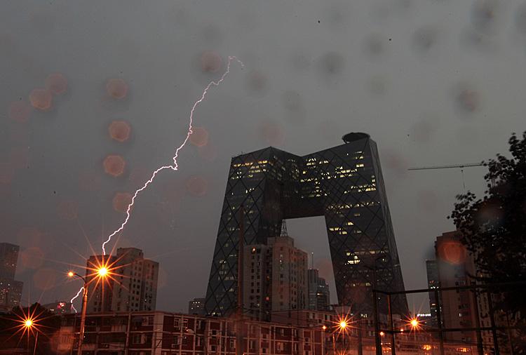 Lightning strikes downtown Beijing in July 2011. In the foreground is the headquarters of the Chinese regime's mouthpiece China Central TV. The political storm raging in Beijing requires each of us to take a stand. (ChinaFotoPress/Getty Images)