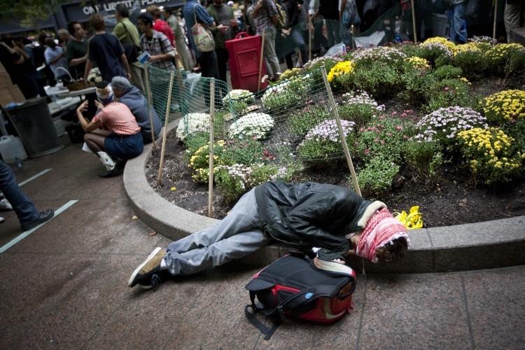 <a><img src="https://www.theepochtimes.com/assets/uploads/2015/09/129219859ii.jpg" alt="An Occupy Wall Street demonstrator sleeps in Zuccotti Park after marching in the financial district on October 14, 2011 in New York City. (Michael Nagle/Getty Images)" title="An Occupy Wall Street demonstrator sleeps in Zuccotti Park after marching in the financial district on October 14, 2011 in New York City. (Michael Nagle/Getty Images)" width="575" class="size-medium wp-image-1796391"/></a>