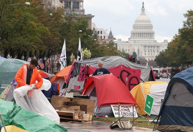 <a><img src="https://www.theepochtimes.com/assets/uploads/2015/09/129220025.jpg" alt="Protesters stand in a temporally encampment at Freedom Plaza, on October 14, 2011 in Washington, D.C. (Mark Wilson/Getty Images)" title="Protesters stand in a temporally encampment at Freedom Plaza, on October 14, 2011 in Washington, D.C. (Mark Wilson/Getty Images)" width="575" class="size-medium wp-image-1796369"/></a>