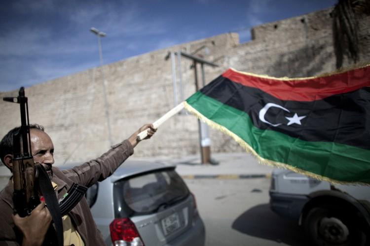 <a><img src="https://www.theepochtimes.com/assets/uploads/2015/09/129722977.jpg" alt="A Libyan fighter waves a National Transitional Council (NTC) flag as he celebrates in the streets of Tripoli following news of Muammar Gaddafi's capture on Oct. 20. (MARCO LONGARI/AFP/Getty Images)" title="A Libyan fighter waves a National Transitional Council (NTC) flag as he celebrates in the streets of Tripoli following news of Muammar Gaddafi's capture on Oct. 20. (MARCO LONGARI/AFP/Getty Images)" width="575" class="size-medium wp-image-1796060"/></a>