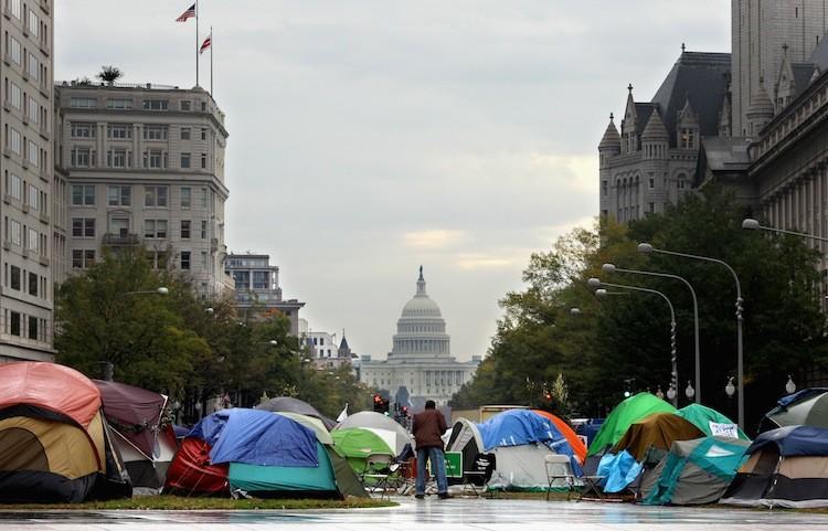 <a><img src="https://www.theepochtimes.com/assets/uploads/2015/09/130625162.jpg" alt="Dozens of people sleep in tents set up as part of the Stop the Machine protest in Freedom Plaza on Pennsylvania Avenue between the White House and the U.S. Capitol Oct. 27, in Washington, D.C.  (Chip Somodevilla/Getty Images)" title="Dozens of people sleep in tents set up as part of the Stop the Machine protest in Freedom Plaza on Pennsylvania Avenue between the White House and the U.S. Capitol Oct. 27, in Washington, D.C.  (Chip Somodevilla/Getty Images)" width="575" class="size-medium wp-image-1795371"/></a>