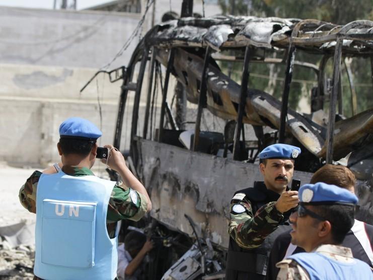 <a><img class="size-full wp-image-1786099" title="UN observers photograph the scene by a bombed bus outside a Shiite holy shrine in the Sayyida Zeinab suburb of Damascus on June 14, 2012. (LouaiBesgara/AFP/GettyImages)" src="https://www.theepochtimes.com/assets/uploads/2015/09/146314787.jpg" alt="" width="741" height="556"/></a>