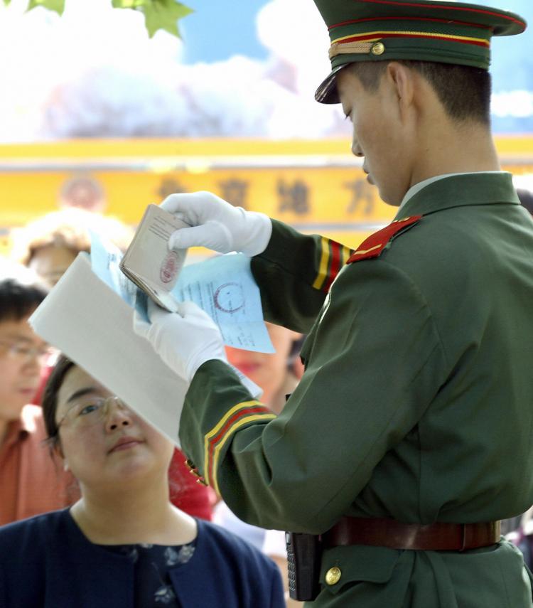 <a><img src="https://www.theepochtimes.com/assets/uploads/2015/09/50846430_passpor.jpg" alt="CONTROL: A Chinese paramilitary guard checks the passport of a U.S. visa applicant as she arrives for her appointment to submit her application at the U.S. Embassy in Beijing on May 17, 2004. (Goh Chai Hin/Getty Images )" title="CONTROL: A Chinese paramilitary guard checks the passport of a U.S. visa applicant as she arrives for her appointment to submit her application at the U.S. Embassy in Beijing on May 17, 2004. (Goh Chai Hin/Getty Images )" width="320" class="size-medium wp-image-1806048"/></a>