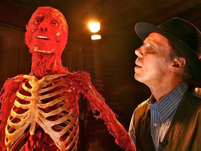 Professor Gunther von Hagens stands next to one of his plastinated bodies prior to the launch of an exhibition, on Feb. 21, 2008, in Manchester, England. Chinese netizens and press are curious about where exhibitions such as this one obtained their genuine human bodies. (Christopher Furlong/Getty Images)