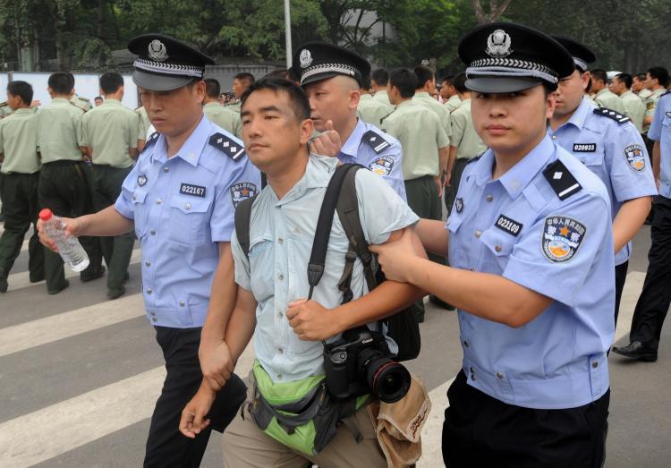 <a><img src="https://www.theepochtimes.com/assets/uploads/2015/09/82060256.jpg" alt="Chinese police detain a newspaper photographer Felix Wong from Hong Kong, who was photographing people waiting to buy the final batch of Olympic tickets, on sale near the Olympic Stadium in Beijing on July 25, 2008. (Mark Ralston/AFP/Getty Images)" title="Chinese police detain a newspaper photographer Felix Wong from Hong Kong, who was photographing people waiting to buy the final batch of Olympic tickets, on sale near the Olympic Stadium in Beijing on July 25, 2008. (Mark Ralston/AFP/Getty Images)" width="320" class="size-medium wp-image-1834645"/></a>