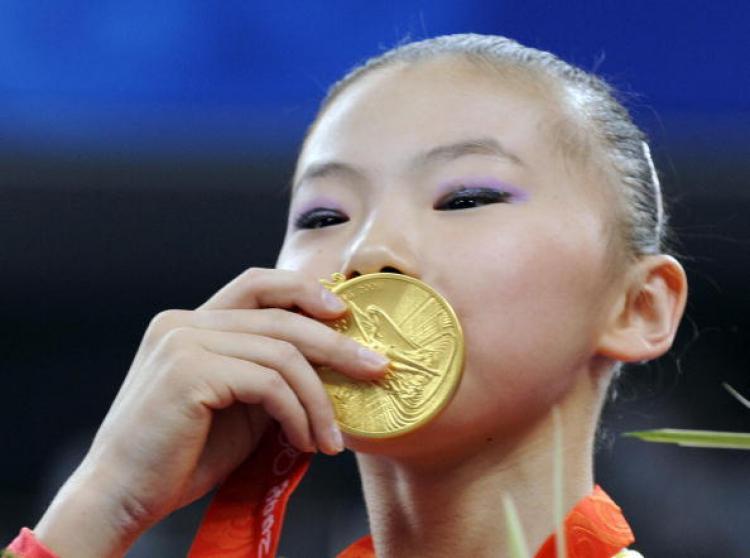 <a><img src="https://www.theepochtimes.com/assets/uploads/2015/09/82401723.jpg" alt="China's He Kexin kisses her gold medal after winning the women's uneven bars final on August 18, 2008. China's Yang Yilin won bronze. Both Chinese gymnasts are at the center of controversy for being underage for Olympic competition. (KAZUHIRO NOGI/AFP/Getty Images)" title="China's He Kexin kisses her gold medal after winning the women's uneven bars final on August 18, 2008. China's Yang Yilin won bronze. Both Chinese gymnasts are at the center of controversy for being underage for Olympic competition. (KAZUHIRO NOGI/AFP/Getty Images)" width="320" class="size-medium wp-image-1834066"/></a>